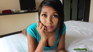 Cute Asian on bed showing cleavage down her top