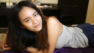 Thai Teen poses on hotel bed