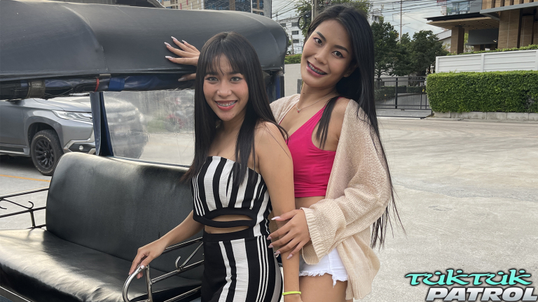 Girls standing beside tuk tuk