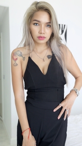 Sexy glamour model TukTuk Patrol Party D stands in sexy black dress