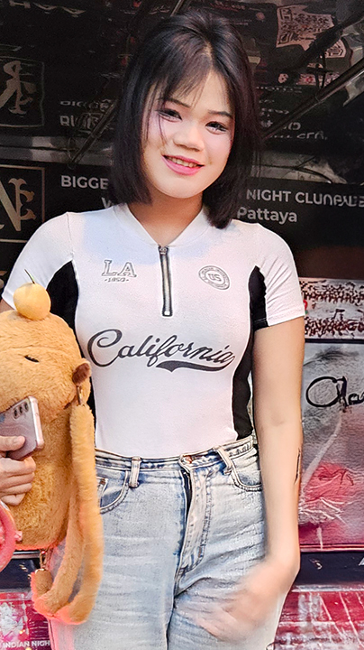 Sexy Thai babe Kama models her hot body in tight top and blue jeans
