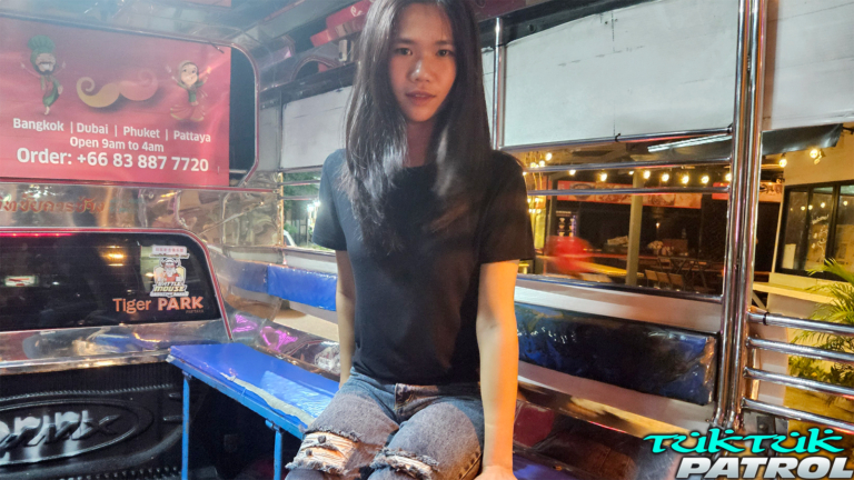 Sitting in back of a tuk tuk vehicle
