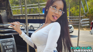 Busty Thai hotty showing tongue while boarding Tuk