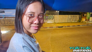 Sexy Thai model wearing glasses while riding tuk
