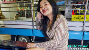 Pretty Thai model smiles while riding tuk in Bangkok